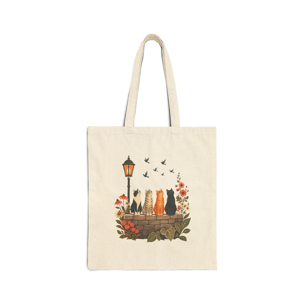 Side B of natural canvas tote showing the same four cats from the front looking toward birds